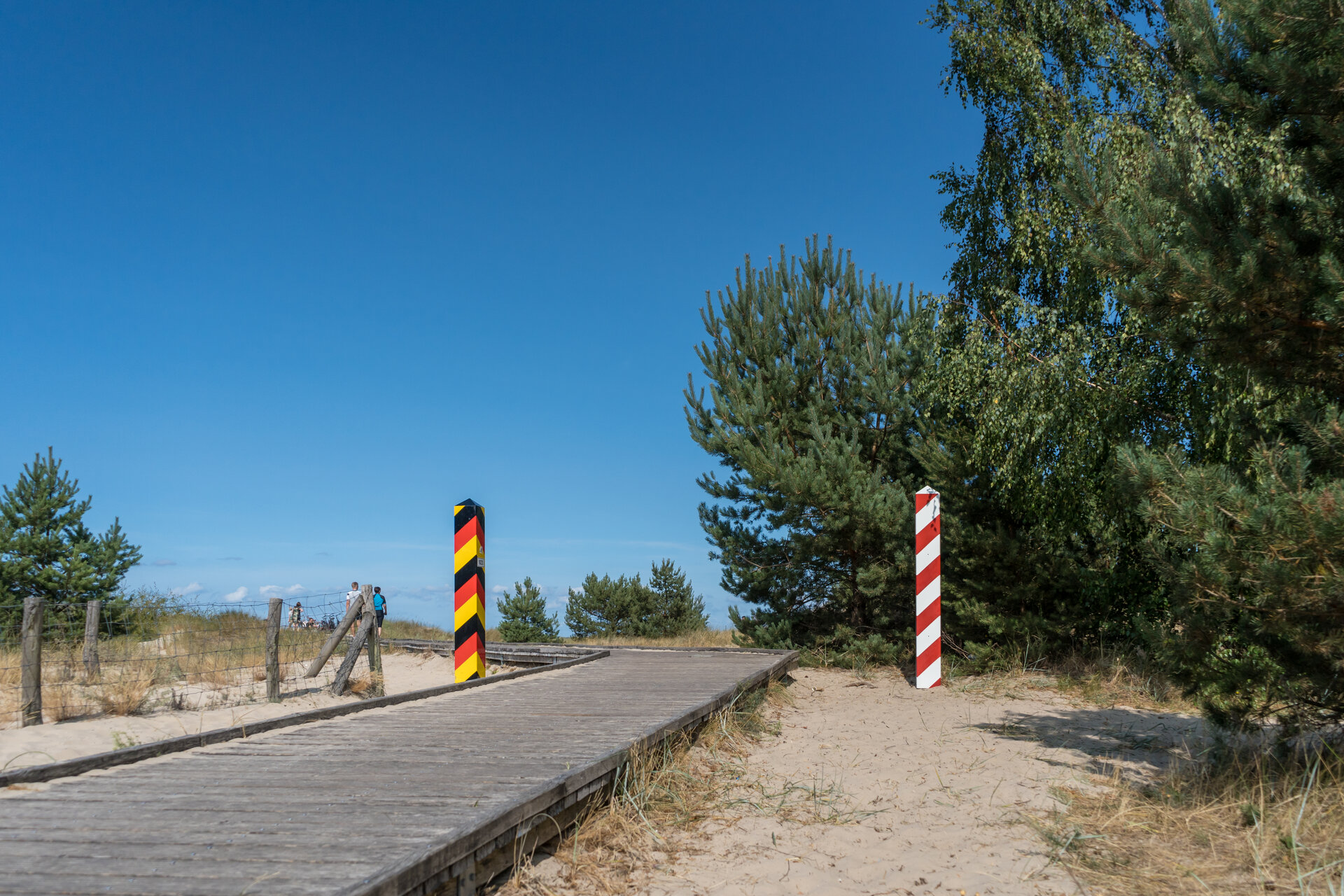 Ein deutscher und ein polnischer Grenzpoller markieren den Verlauf der Grenze.